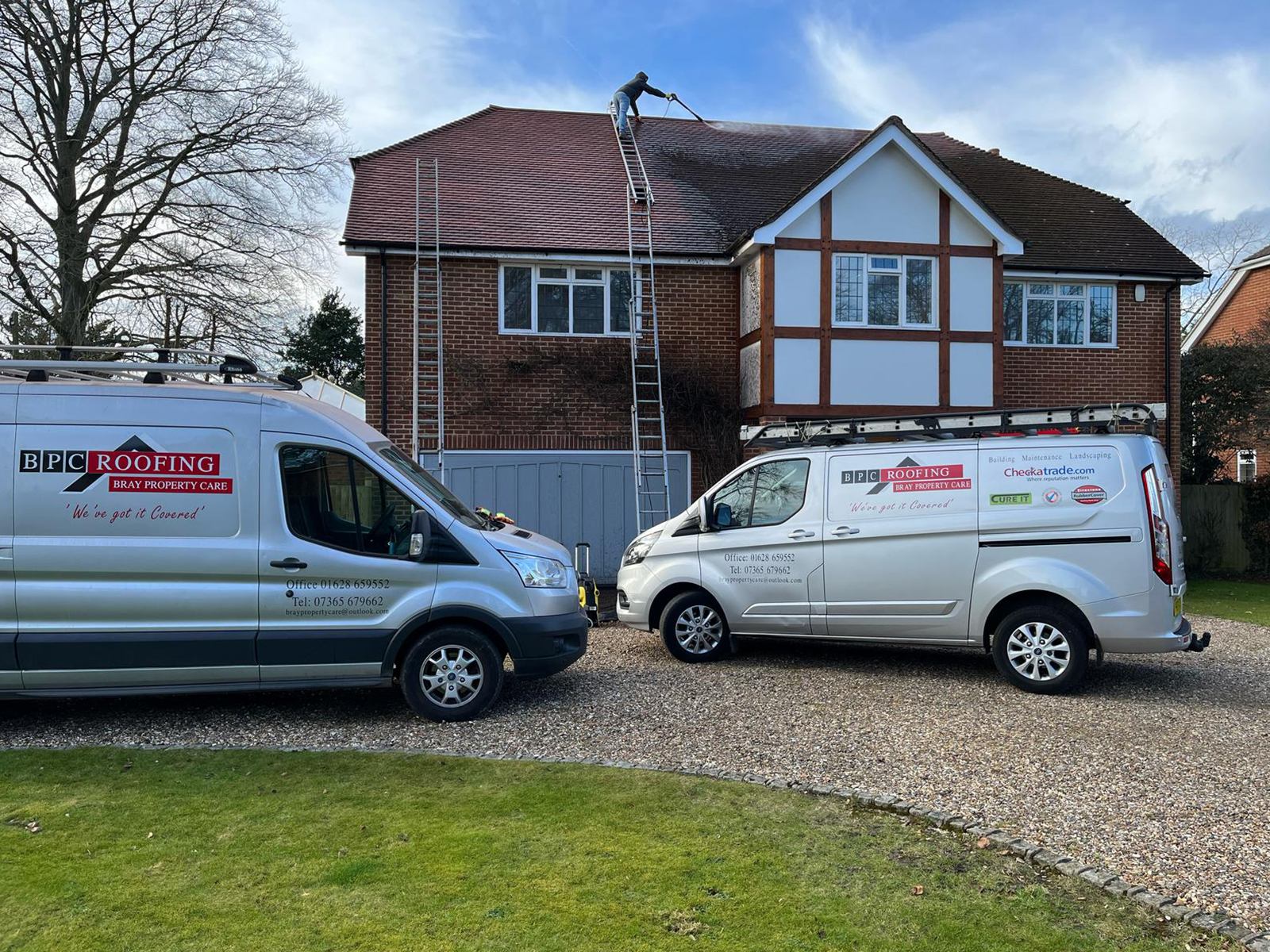 Bray Property Care Roofing vans and roofer carrying out roof work on a property in Berkshire